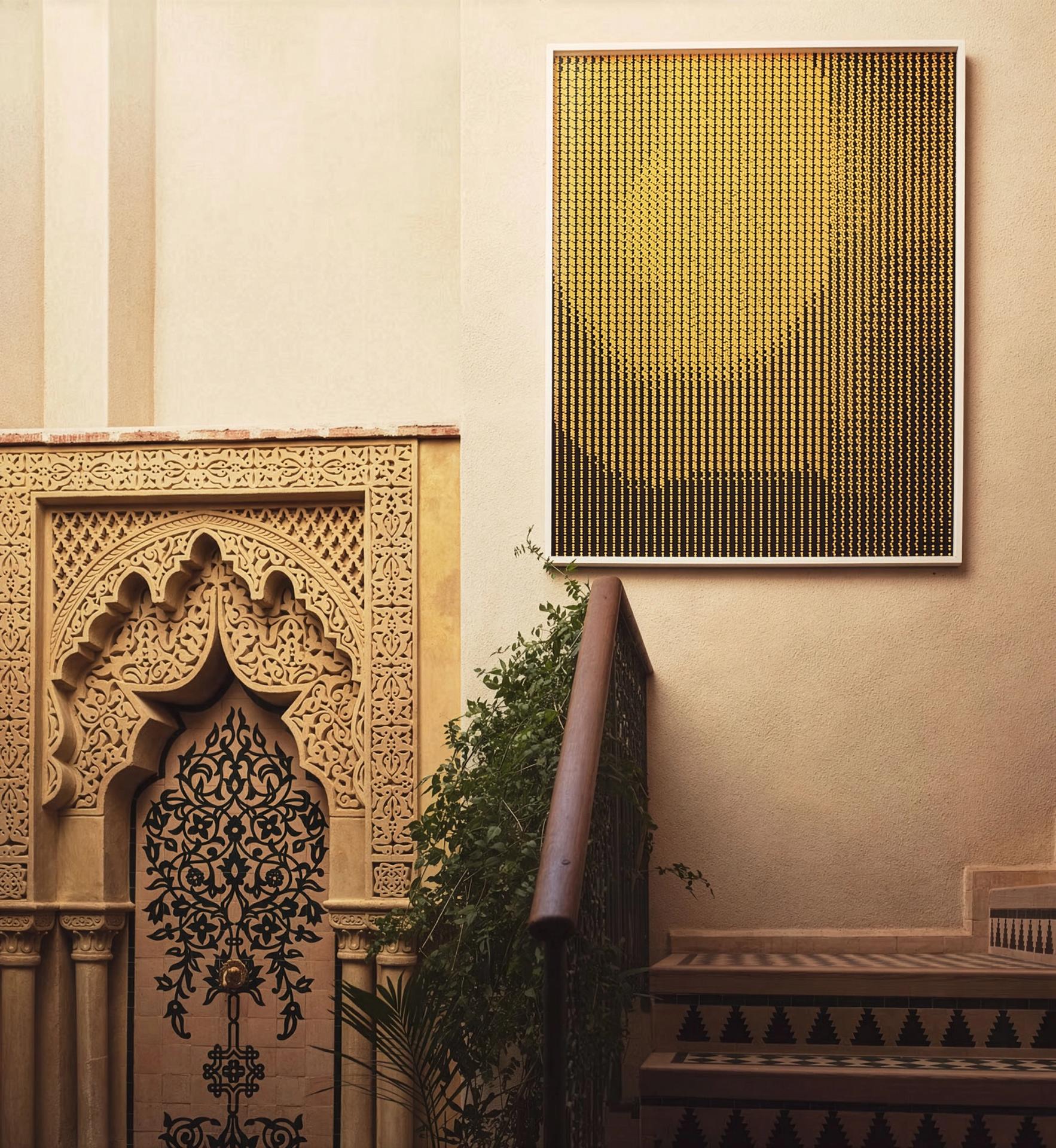 Stucco fireplace niche with golden artwork