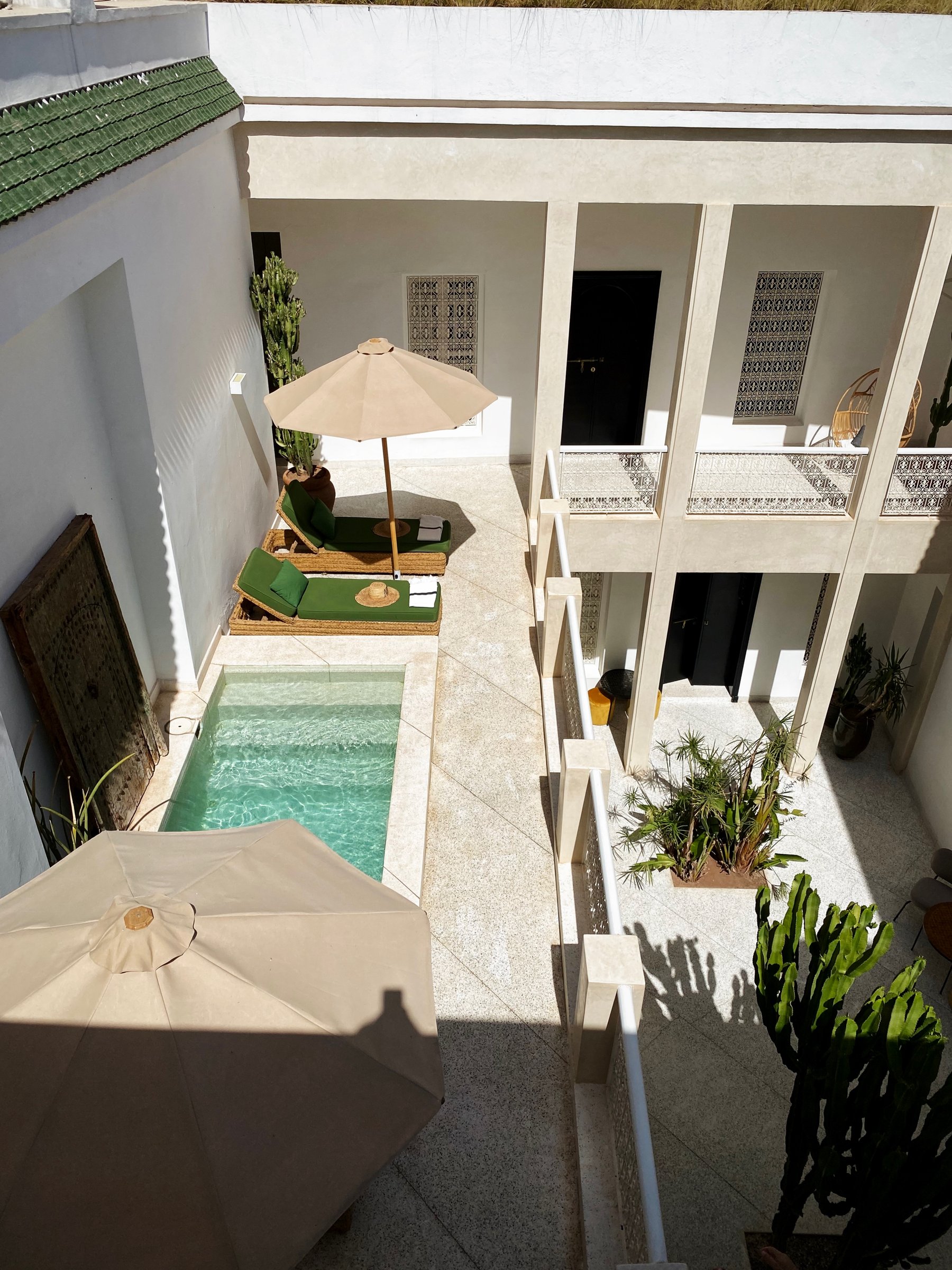Looking down on the pool terrace of Numa from the upper gallery