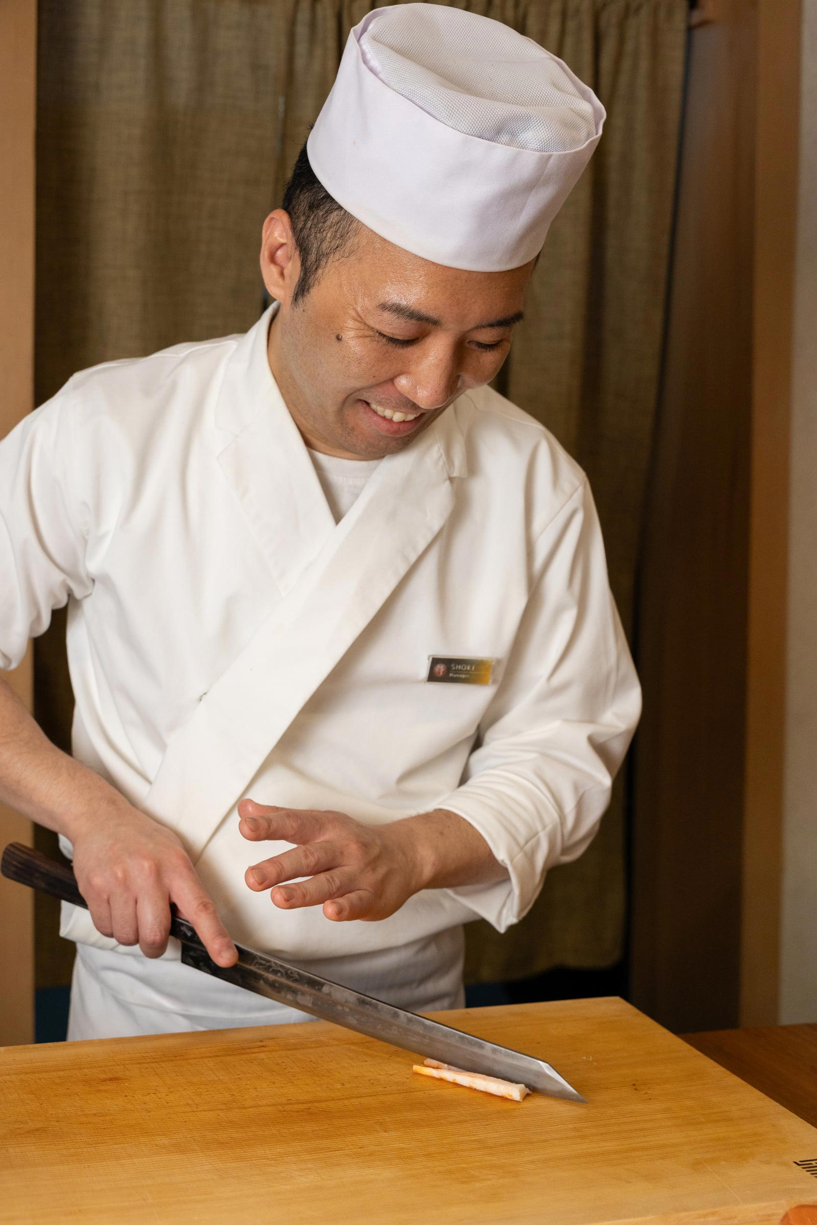 Chef Shoki Yokoyama slicing fish at the IKI counter. Credit Joanne Poinsignon