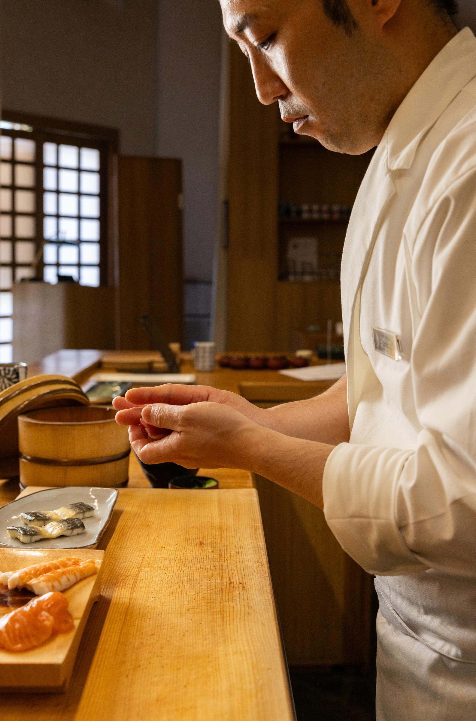 Chef Shoki Yokoyama's hands shaping sushi at the IKI counter. Credit Joanne Poinsignon