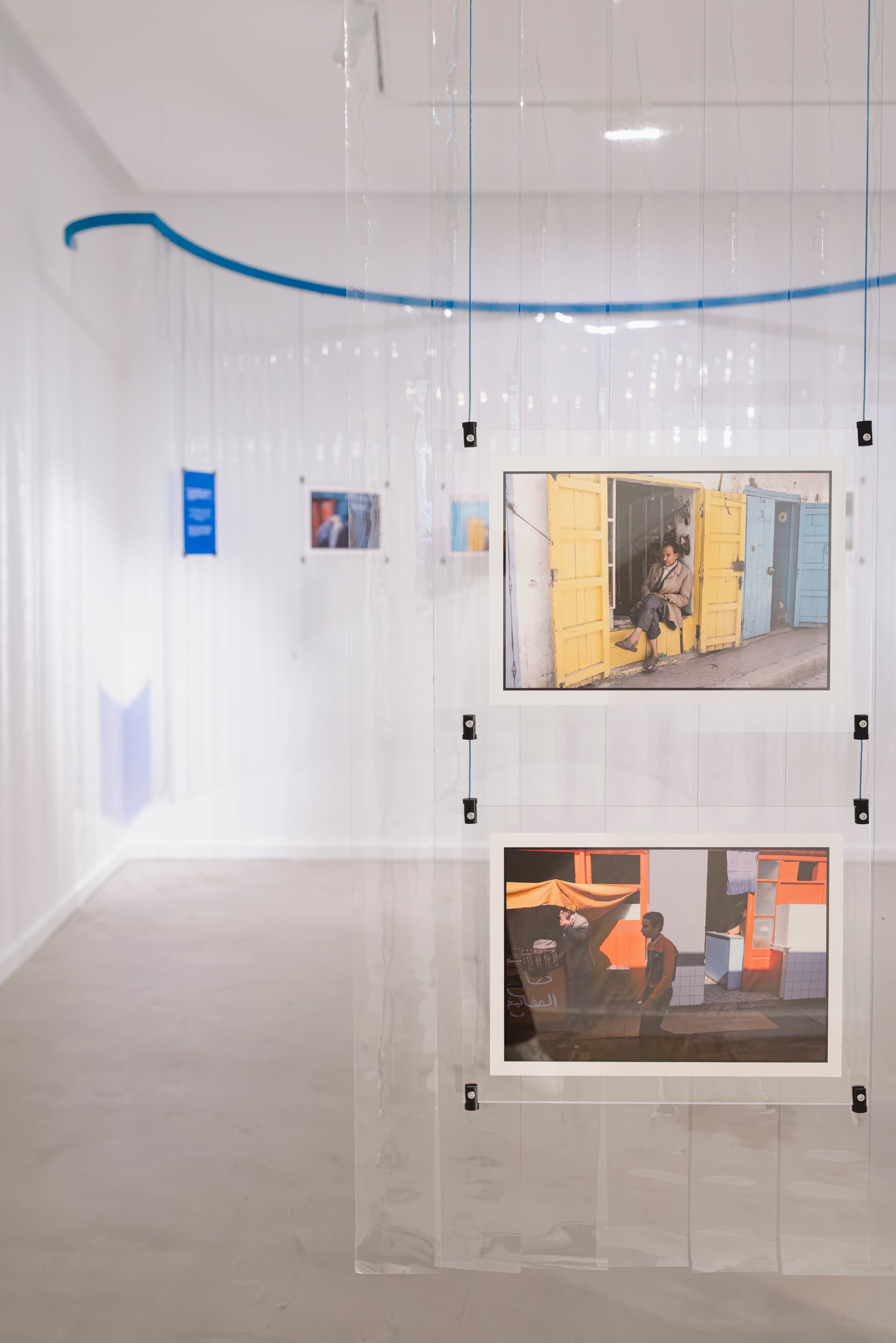 Photographs hung on transparent panels in the Artist Room. Photo: Ayoub El Bardii