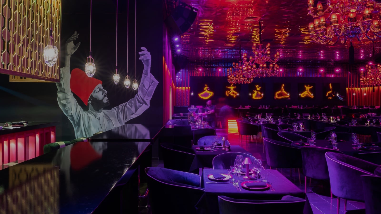 Bar corner near the entrance: black and white whirling dervish mural with a red conical hat, a row of framed dancer portraits with neon-style outlines, gilded fretwork panel by the black bar counter.