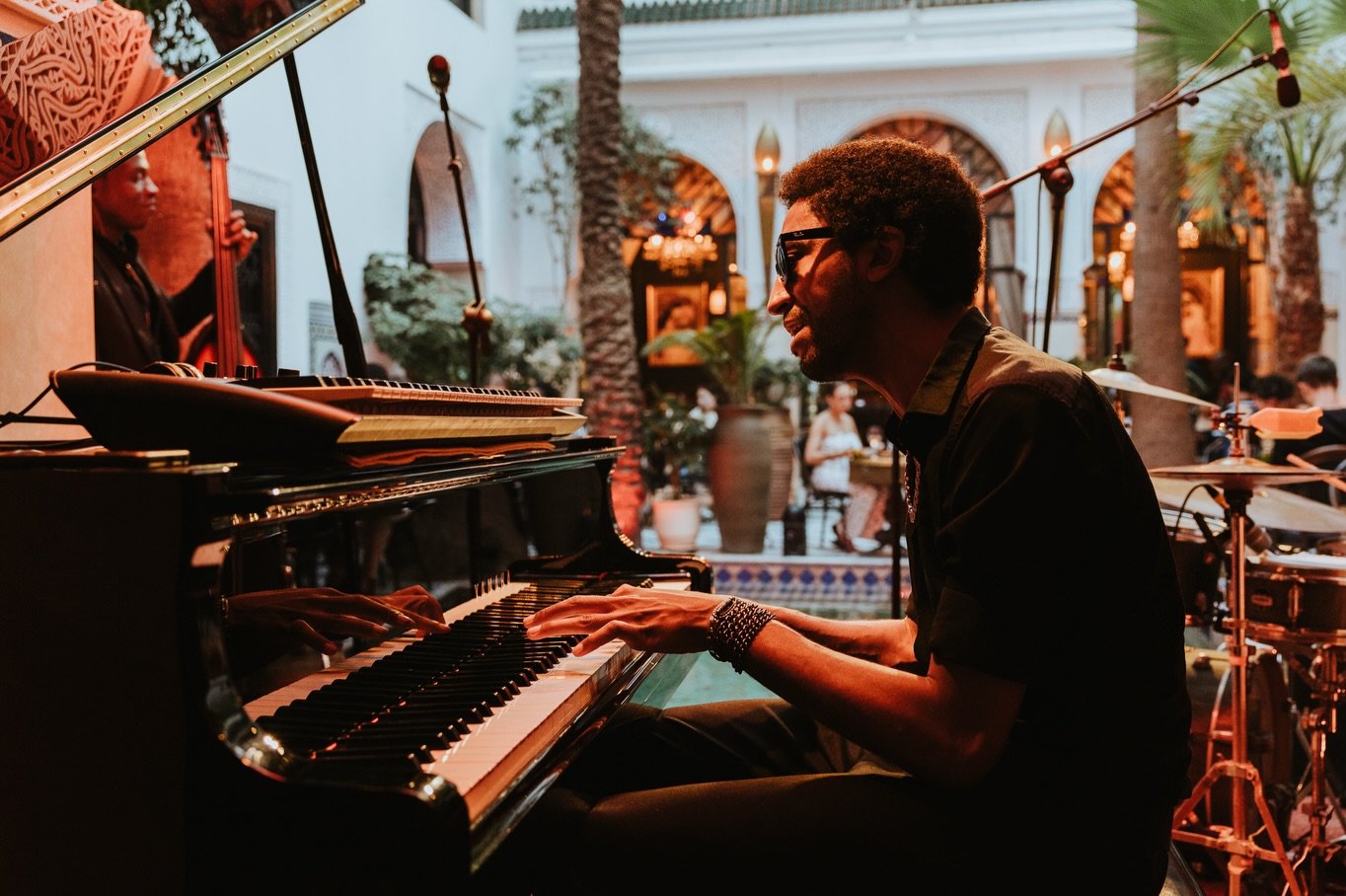 A pianist playing jazz in the courtyard of Riad Monceau, with drums beside him