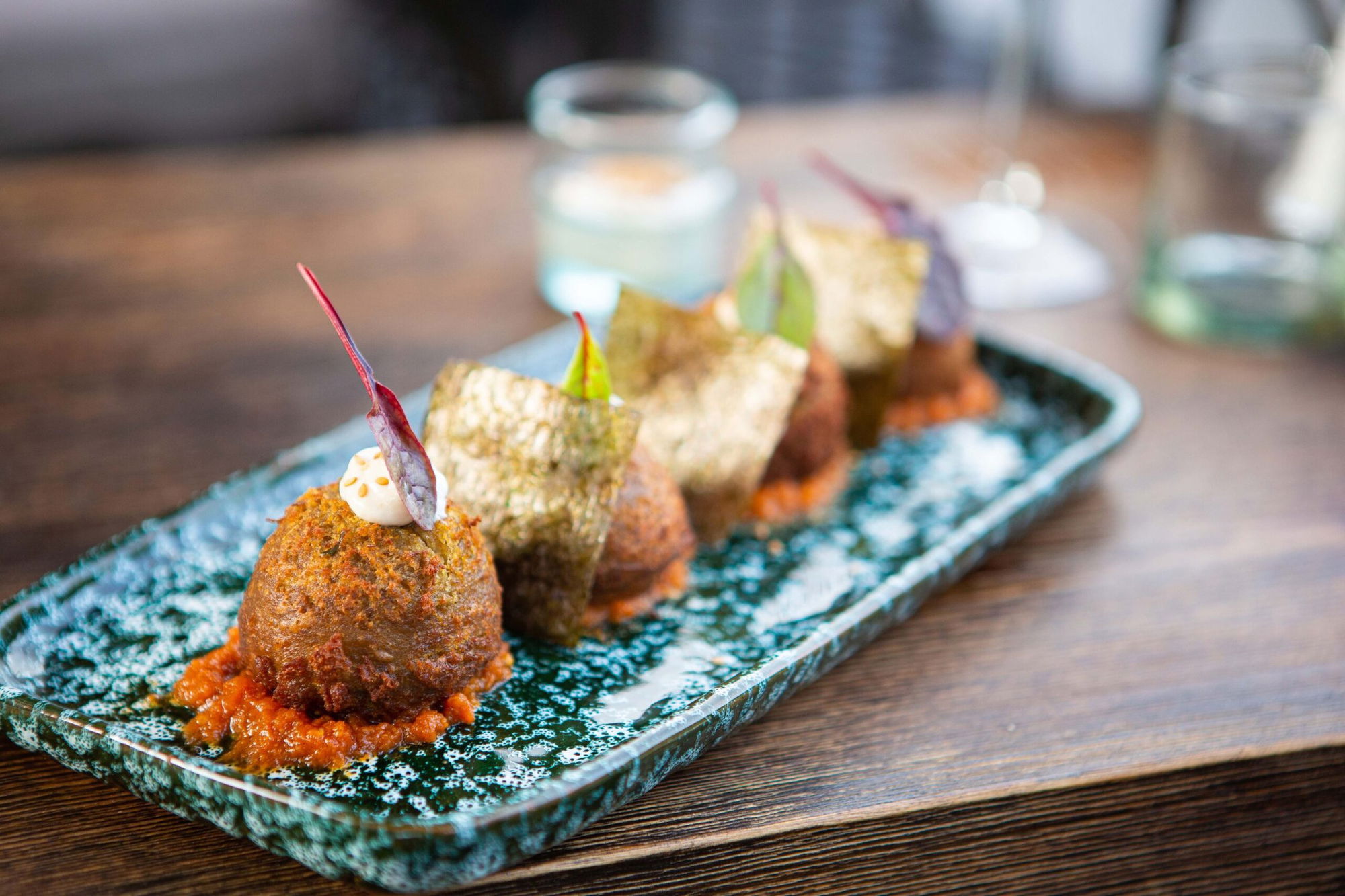 Fried bites on a green ceramic platter at La Pergola