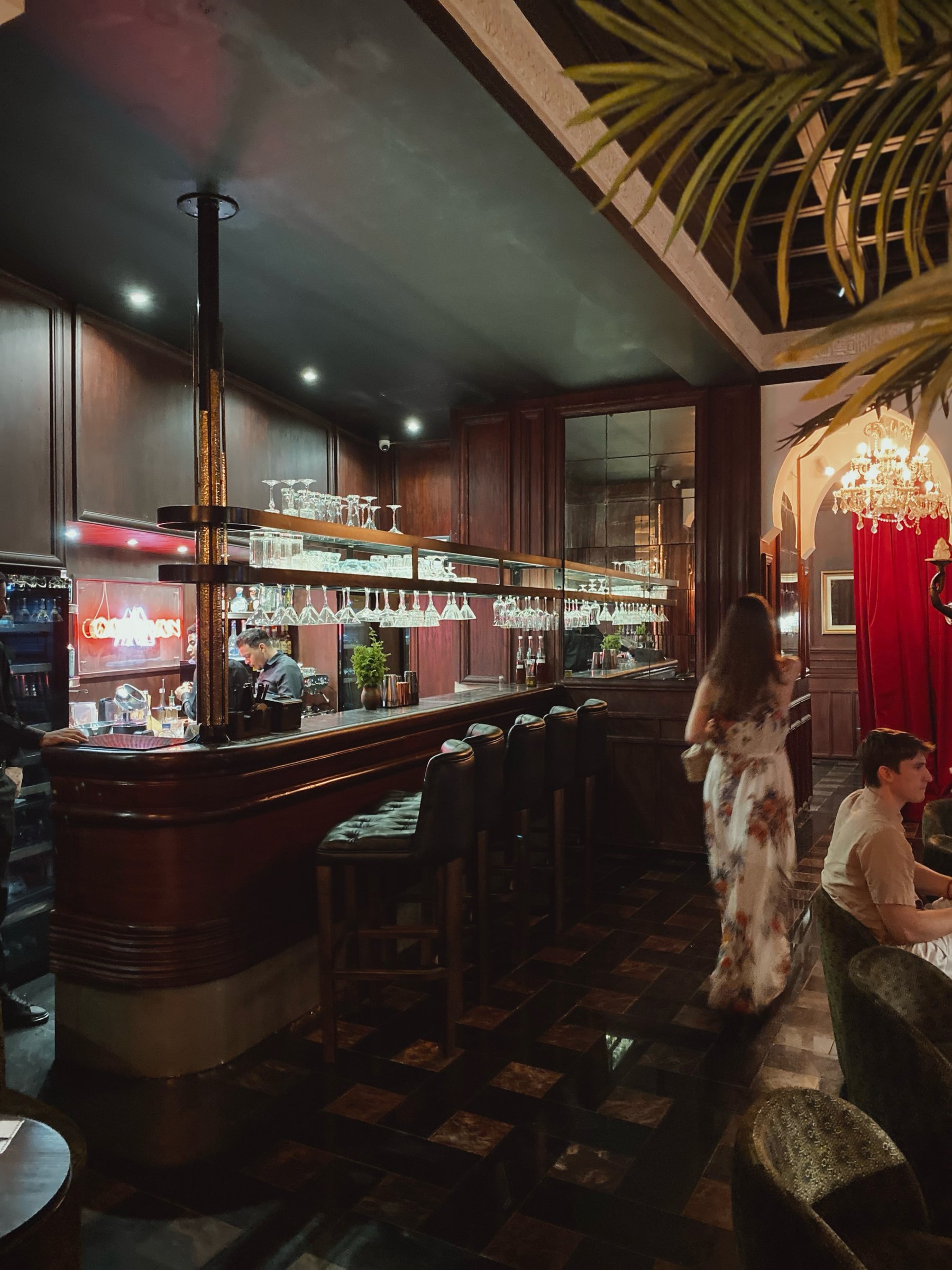 The bar at Le Bistro Arabe, with leather stools under dark wood panelling